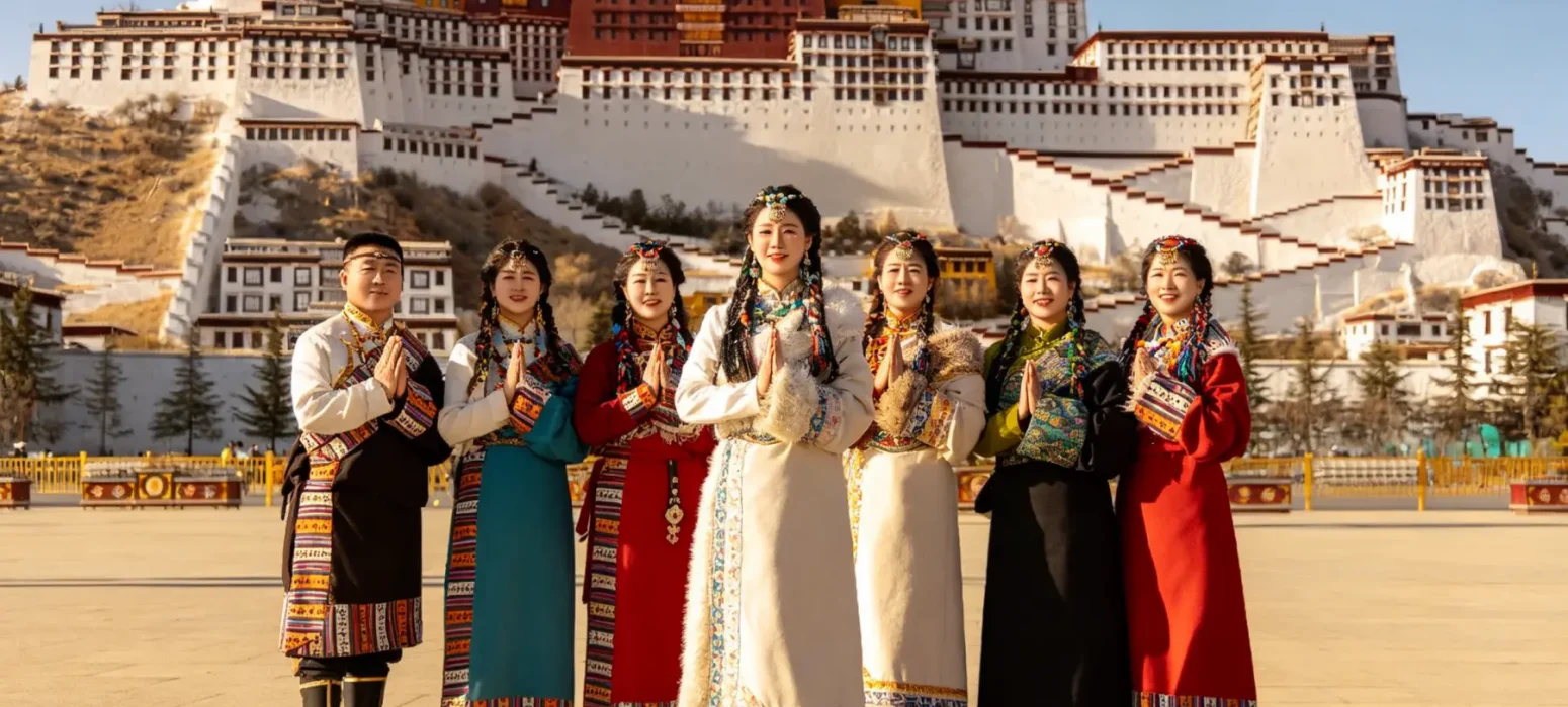 Group Photo in Traditional Tibetan Clothing in Front of the Potala Palace, Lhasa, Tibet, China – Iconic Cultural Travel Experience and Private Tibet Tour | Origin China Travel